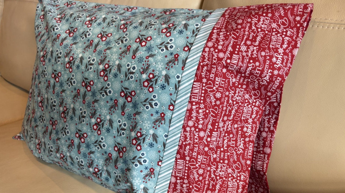 Finished burrito pillowcase with a red cuff and striped flange
